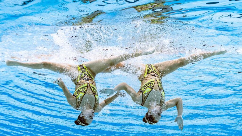 An underwater view shows France's Charlotte Tremble and France's Laura Tremble as they compete in the final of the women's duet free routine artistic swimming event during the Tokyo 2020 Olympic Games at the Tokyo Aquatics Centre in Tokyo on August 4, 2021. (Photo by François-Xavier MARIT / AFP)